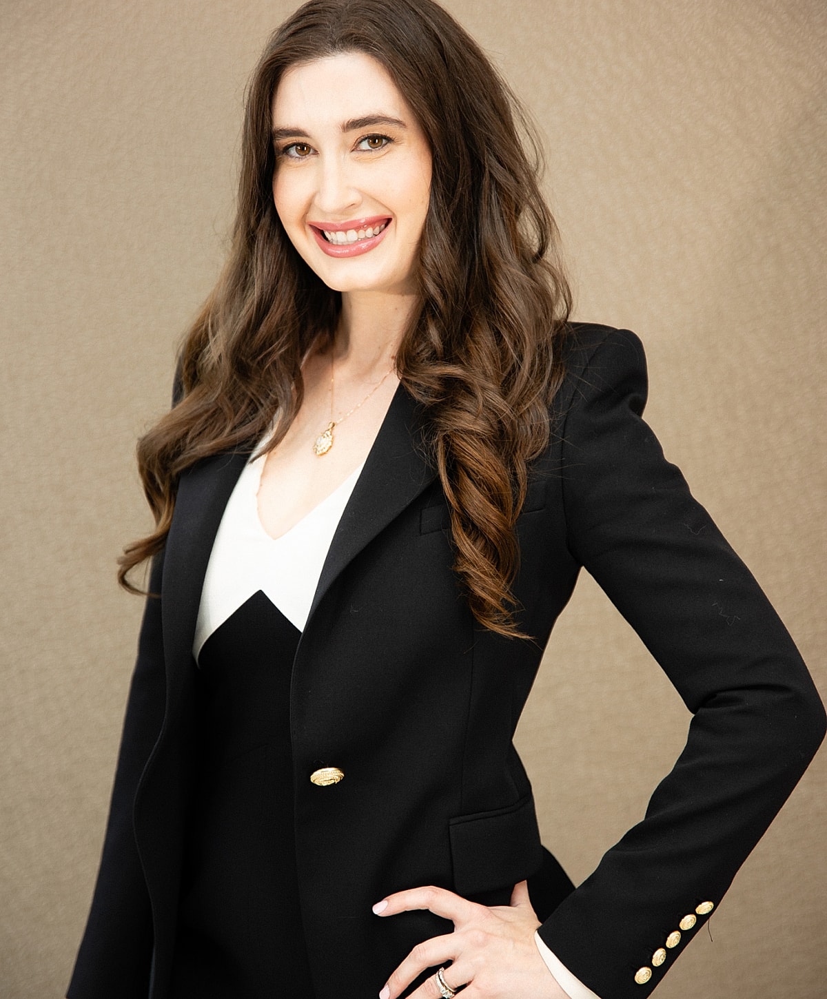 Smiling woman in a professional black blazer.