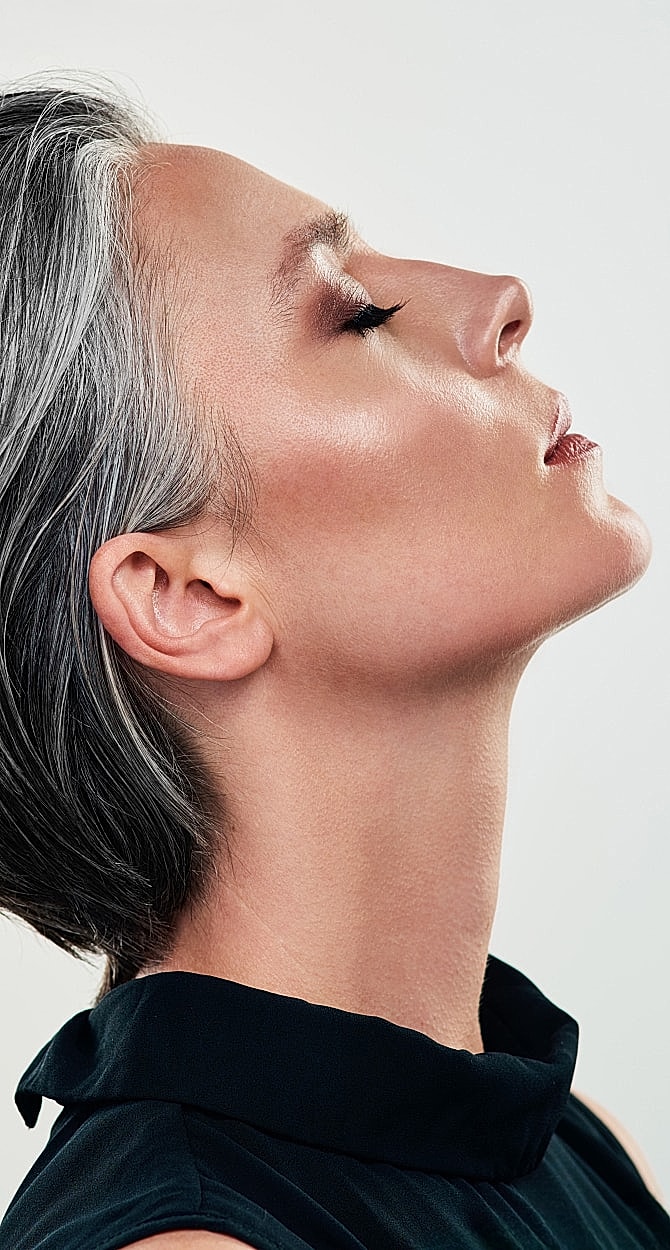 Profile of a woman with gray hair.