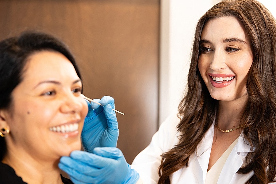 Beauty treatment consultation between two women.